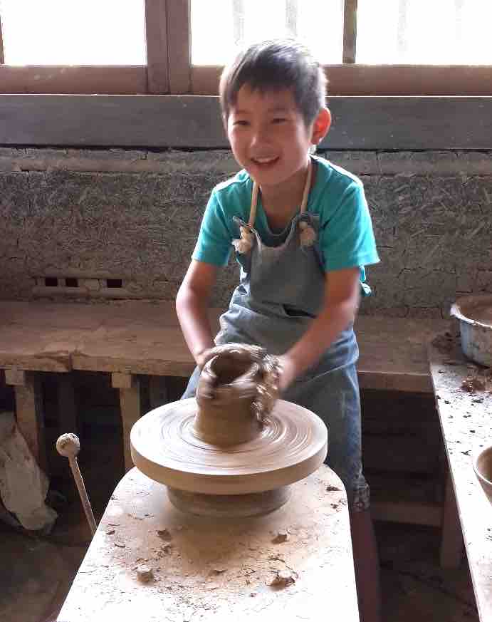 Child making pottery